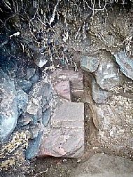 In centre of this view, looking towards the ground, is dressed red sandstone of doorway, incorporating the portcullis slot.